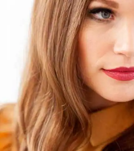 Close-up of a woman with long, wavy, light brown wig in Minnesota.
