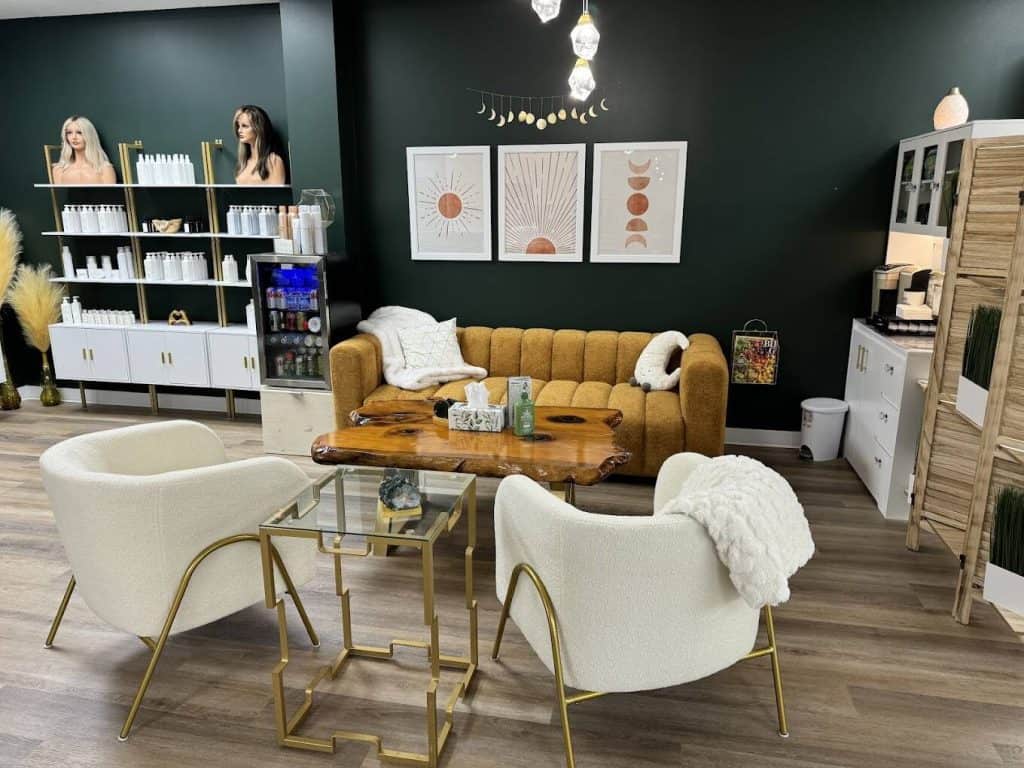 Stylish salon interior with wigs, cozy seating, and modern decor in Minnesota.