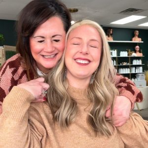 Happy women showcasing wigs at Wigs by Opulence salon in Minnesota.