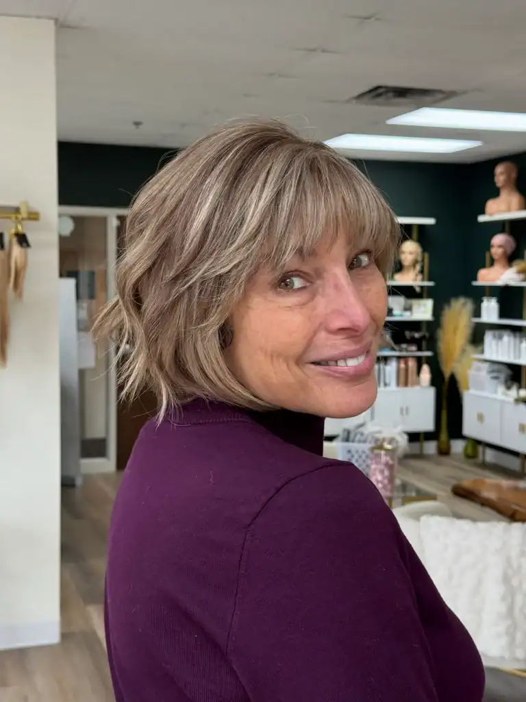 Woman with styled wig at Wigs by Opulence salon in Minnesota.