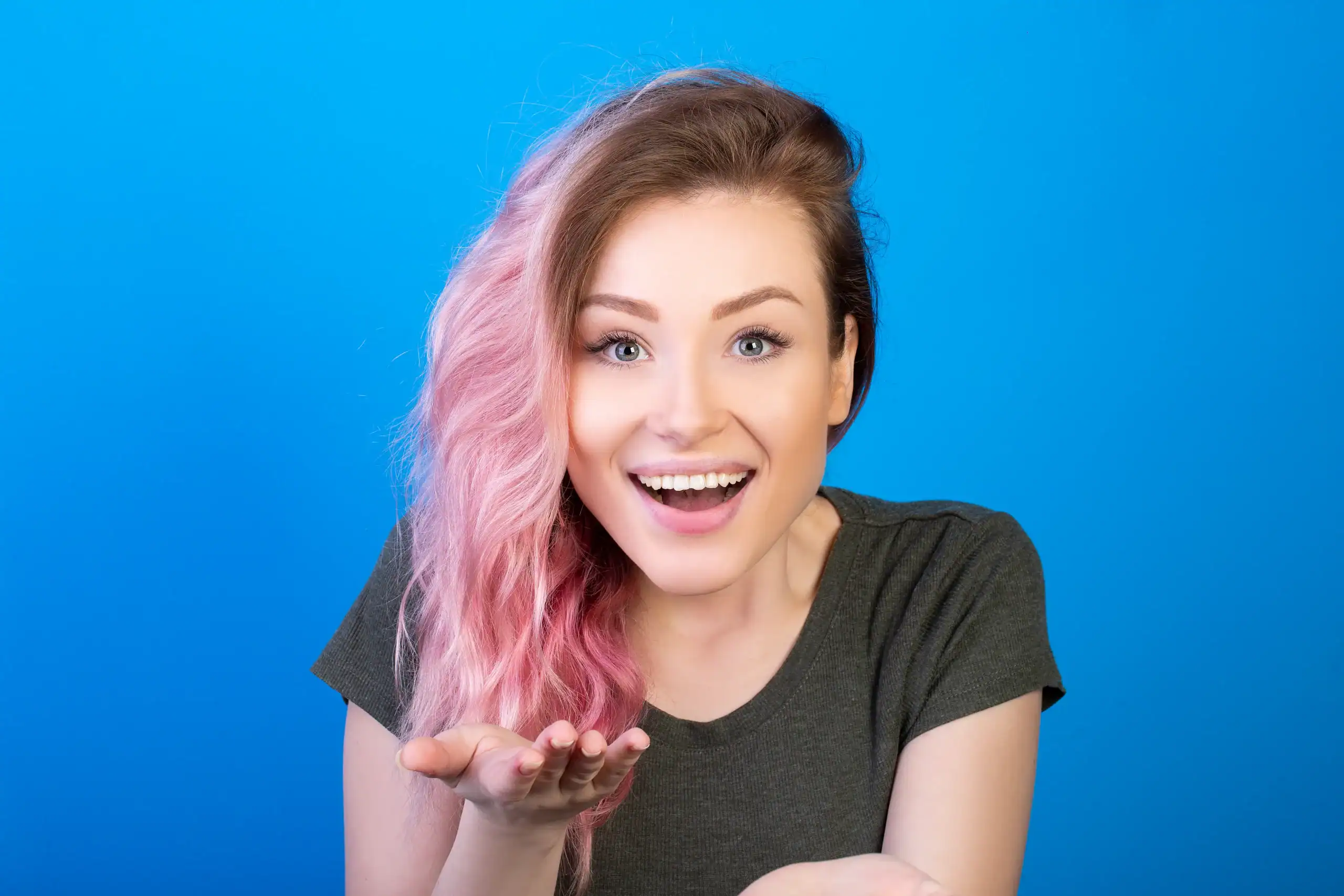 Happy woman with pink and blonde wig in Minnesota salon.