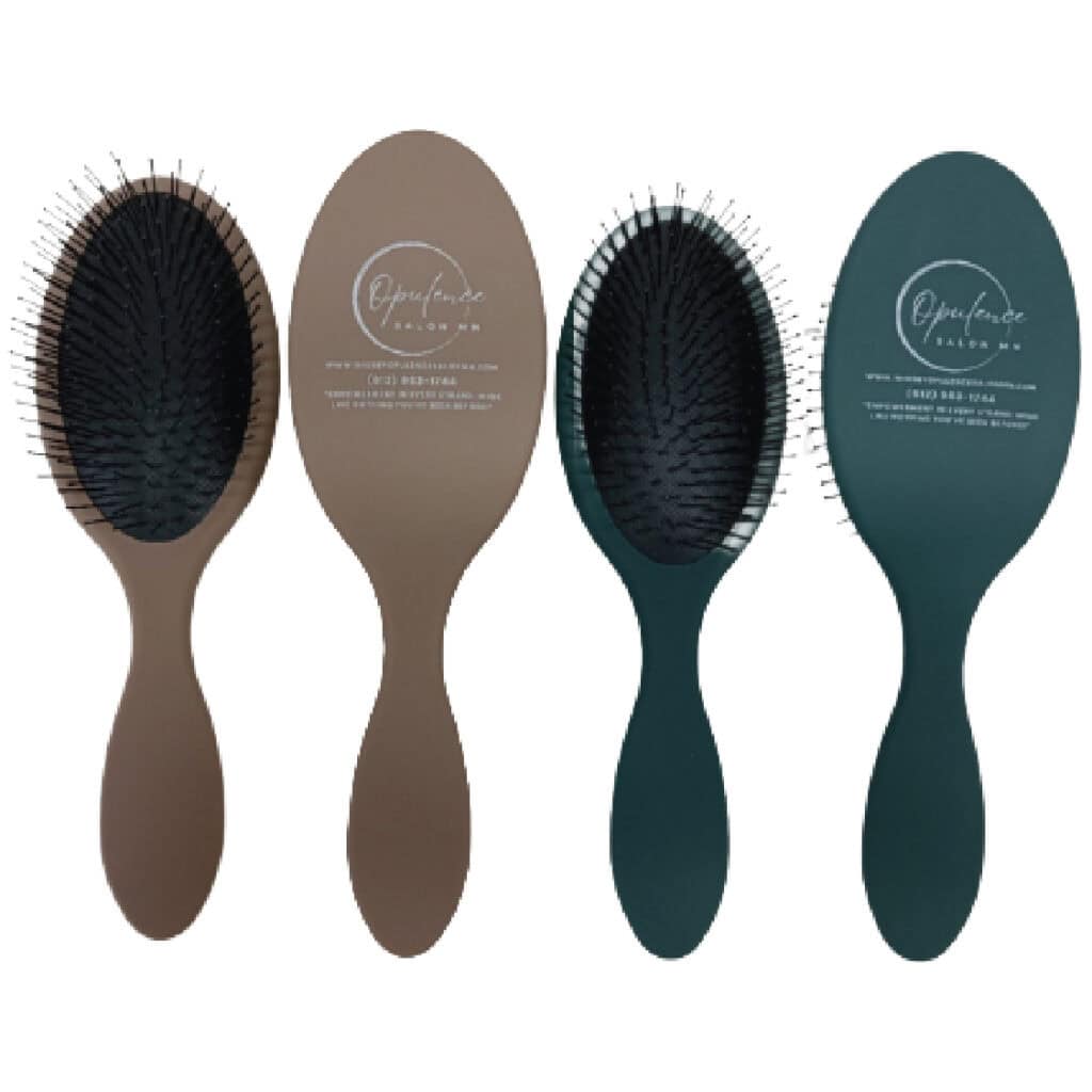 Two hairbrushes with Opulence Salon MN branding for wig care in Minnesota.